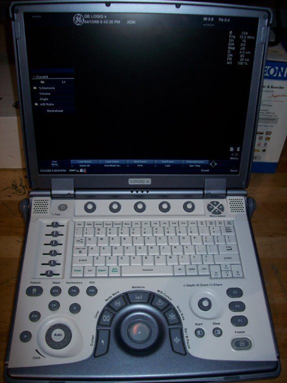 a laptop computer sitting on top of a wooden table