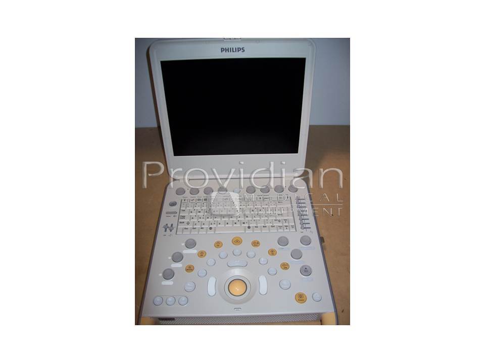 a laptop computer sitting on top of a wooden table