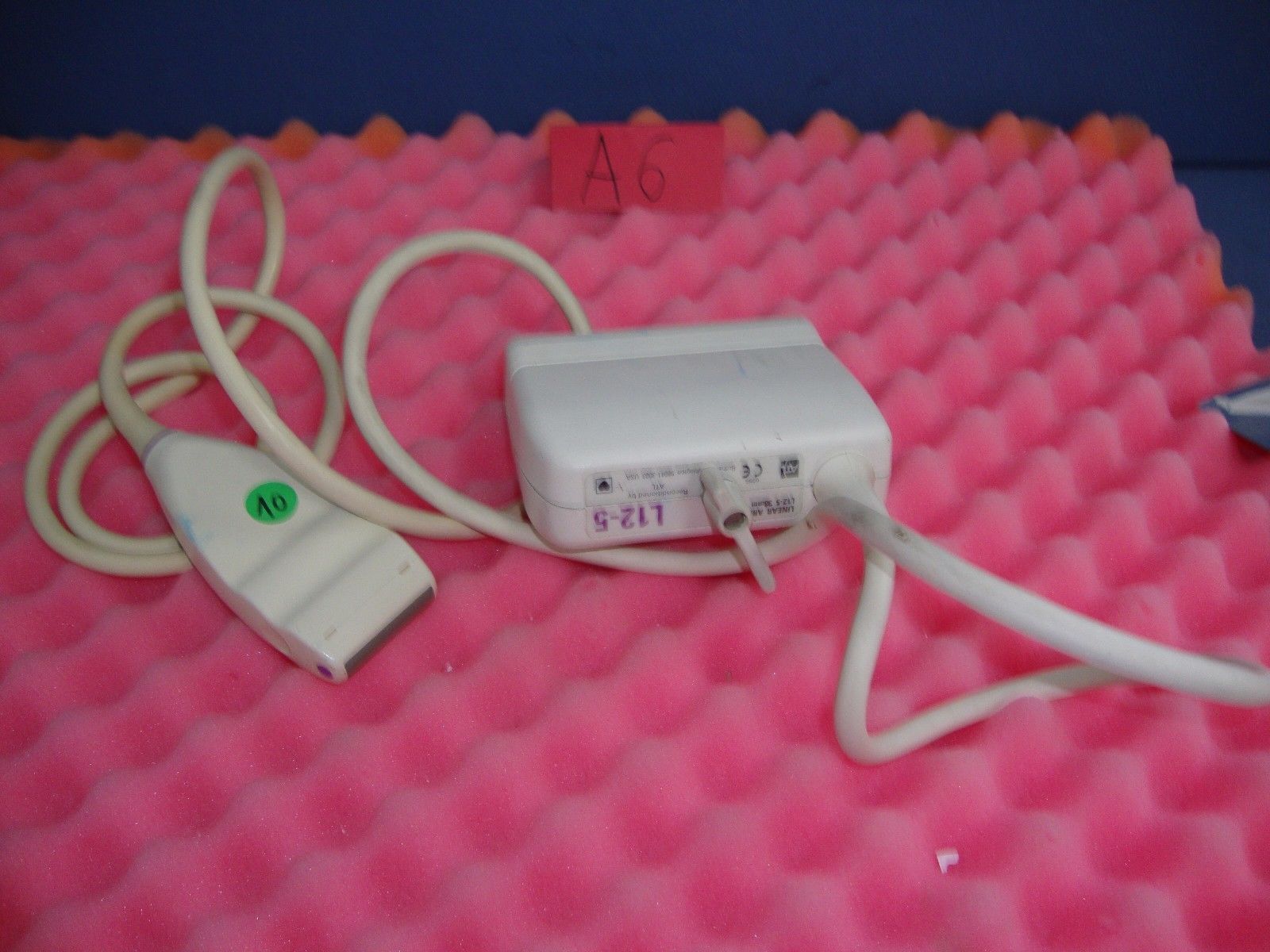 a white probe on a pink surface