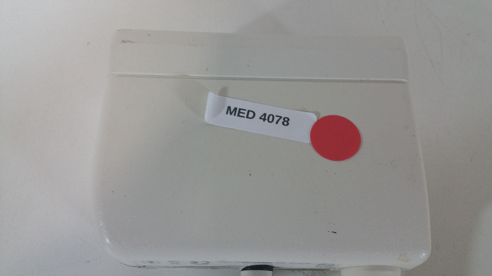 a medical device with a red dot on it